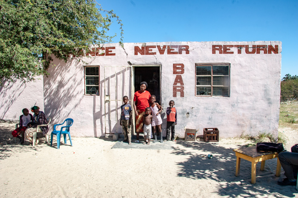 Chance Never Return Bar, with its owner and her children by the entrance. Namibia.